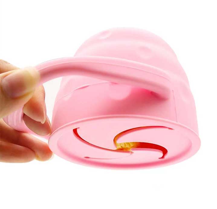 toddler holding silicone snack cup with lid spill proof